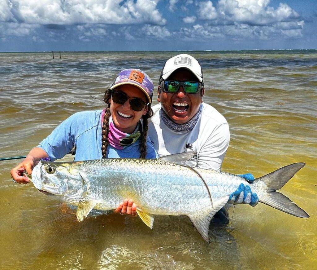 Fly Fishing in Xcalak with Capitan Chepe having a Tarpon in hand.