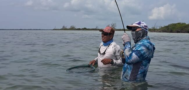 Beginner fly fisher casting for bonefish in Xcalak with guide